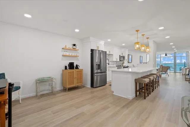 a kitchen with a refrigerator and a sink