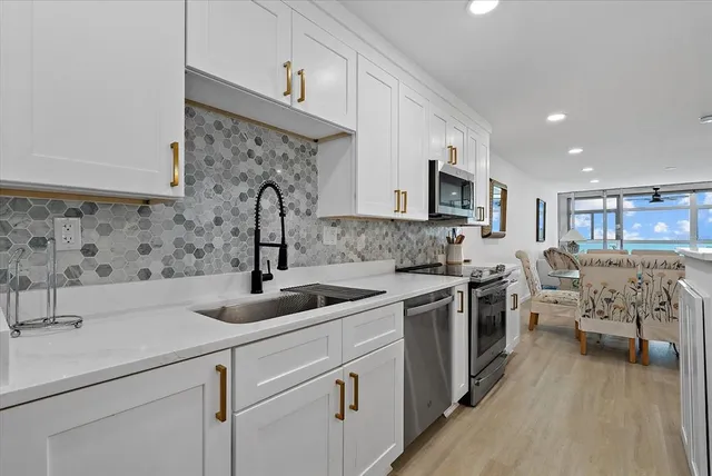 a kitchen with a sink stove and cabinets