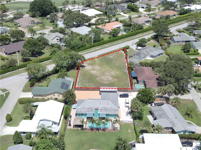 an aerial view of residential houses with outdoor space and street view