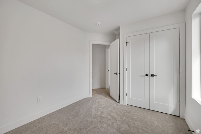 330 East 7635 S Street Sandy, UT 84047 - Photo 20 of 29 Unfurnished bedroom featuring light carpet and a closet