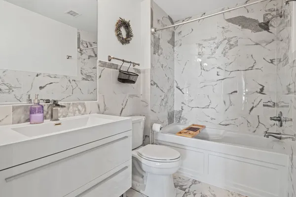 a bathroom with a sink toilet and shower