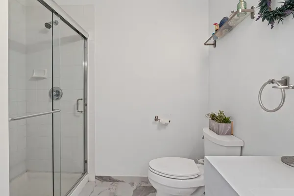 a white toilet sitting next to a bathroom sink