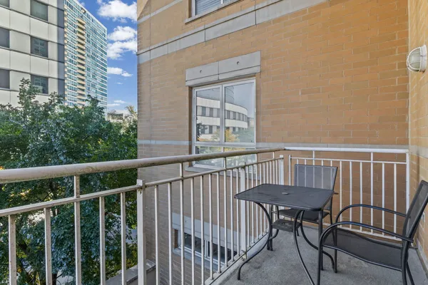 a view of a chair and table in the balcony