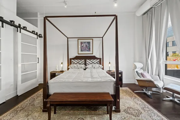 a bed room with a bed window and a table