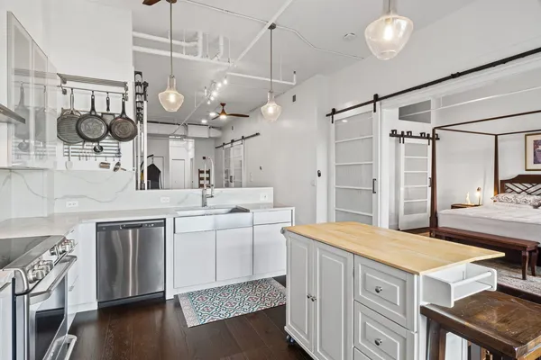 a kitchen with a stove a sink and a refrigerator