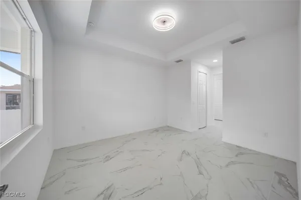 an empty room with a empty space and windows