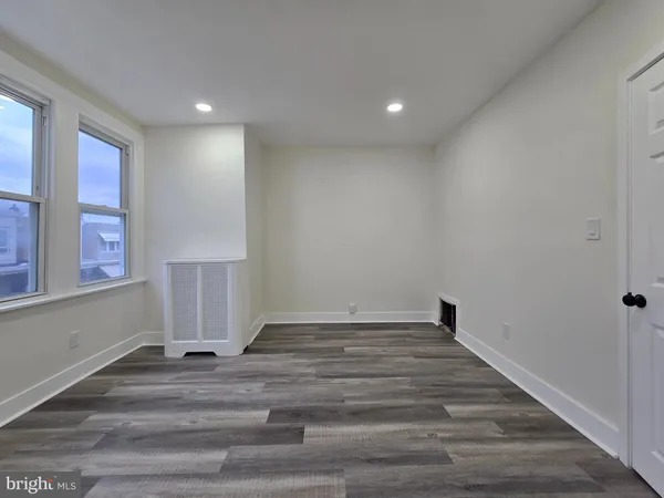 a view of room with stairs and hardwood floor