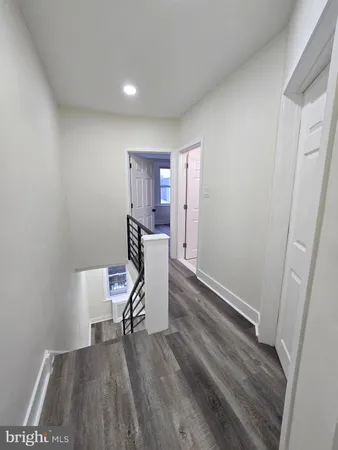 a bathroom with a toilet a sink a mirror and vanity