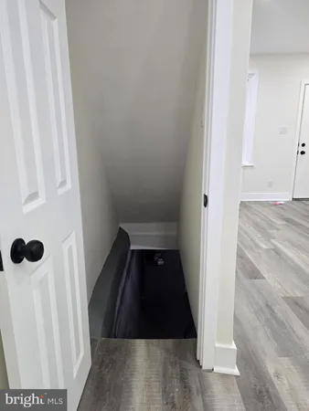 a view of hallway with wooden floor