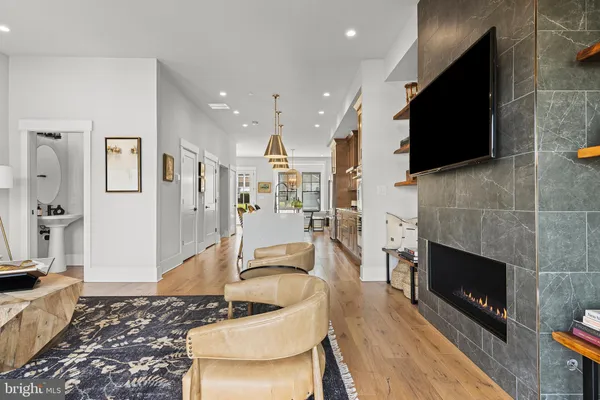 a living room with furniture a flat screen tv and a fireplace