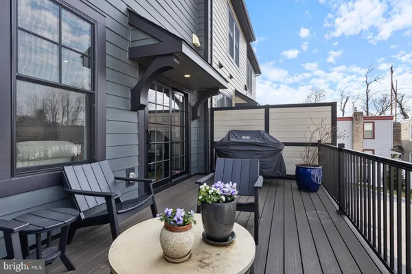 a view of a patio with couches table and chairs and potted plants