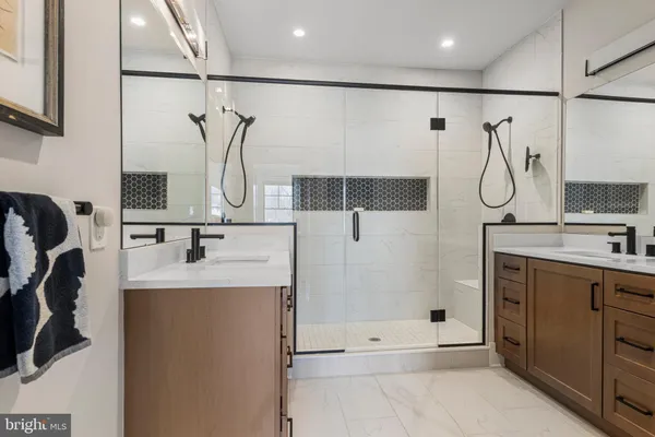 a bathroom with a sink vanity and tub