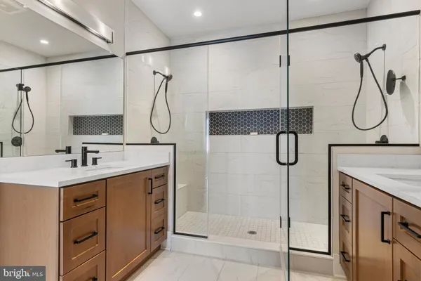 a bathroom with a shower sink and mirror