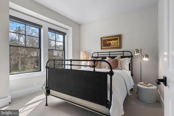a living room with furniture a flat screen tv and windows