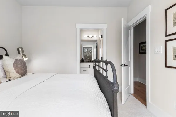 a bedroom with a bed and a large mirror in it