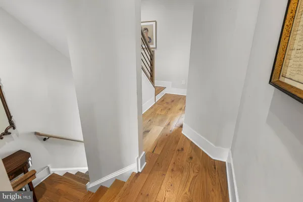 a view of a bedroom with wooden floor and stairs
