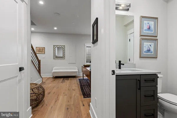 a bathroom with a sink a toilet and a mirror