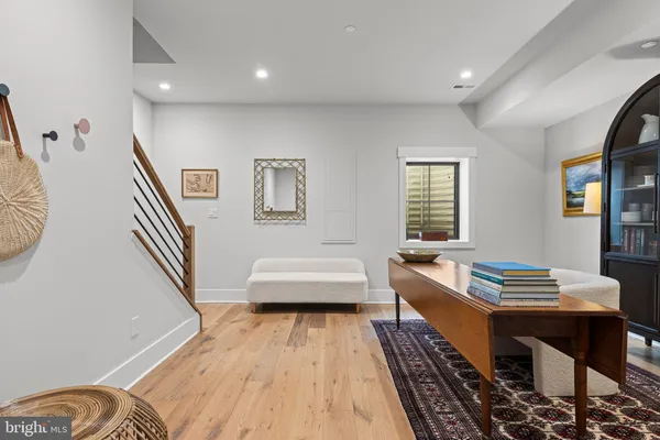 a living room with furniture and a wooden floor