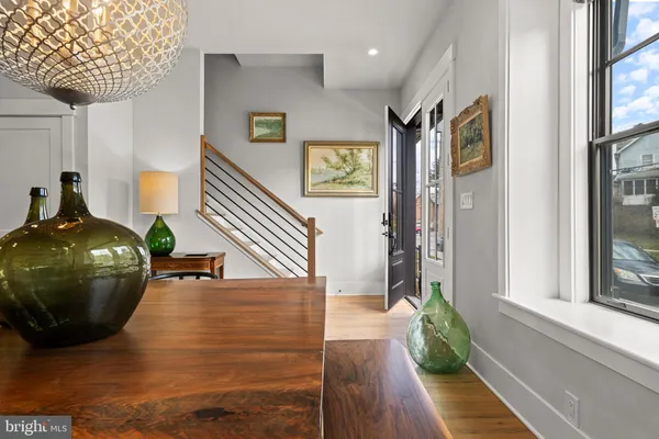 a view of entryway and hall with wooden floor