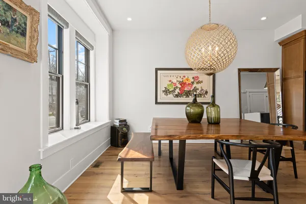 a view of a dining room with furniture wooden floor and chandelier