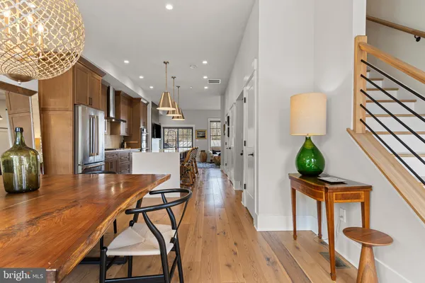 a dining room with furniture and a wooden floor