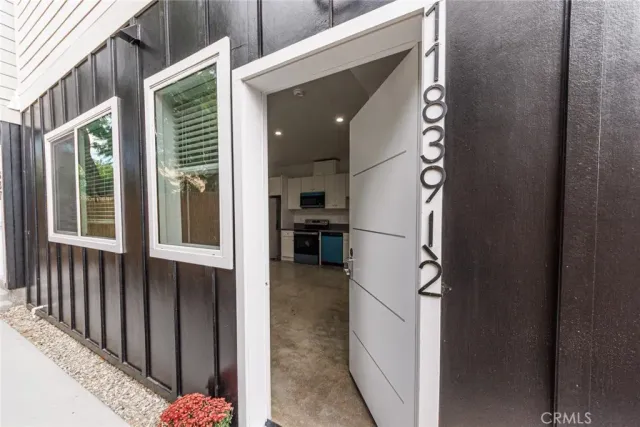 a view of a hallway with wooden shelves and entryway