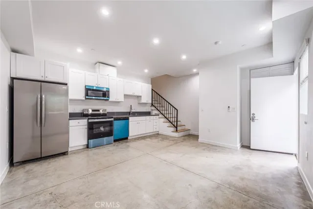 a kitchen with stainless steel appliances a refrigerator and a stove top oven