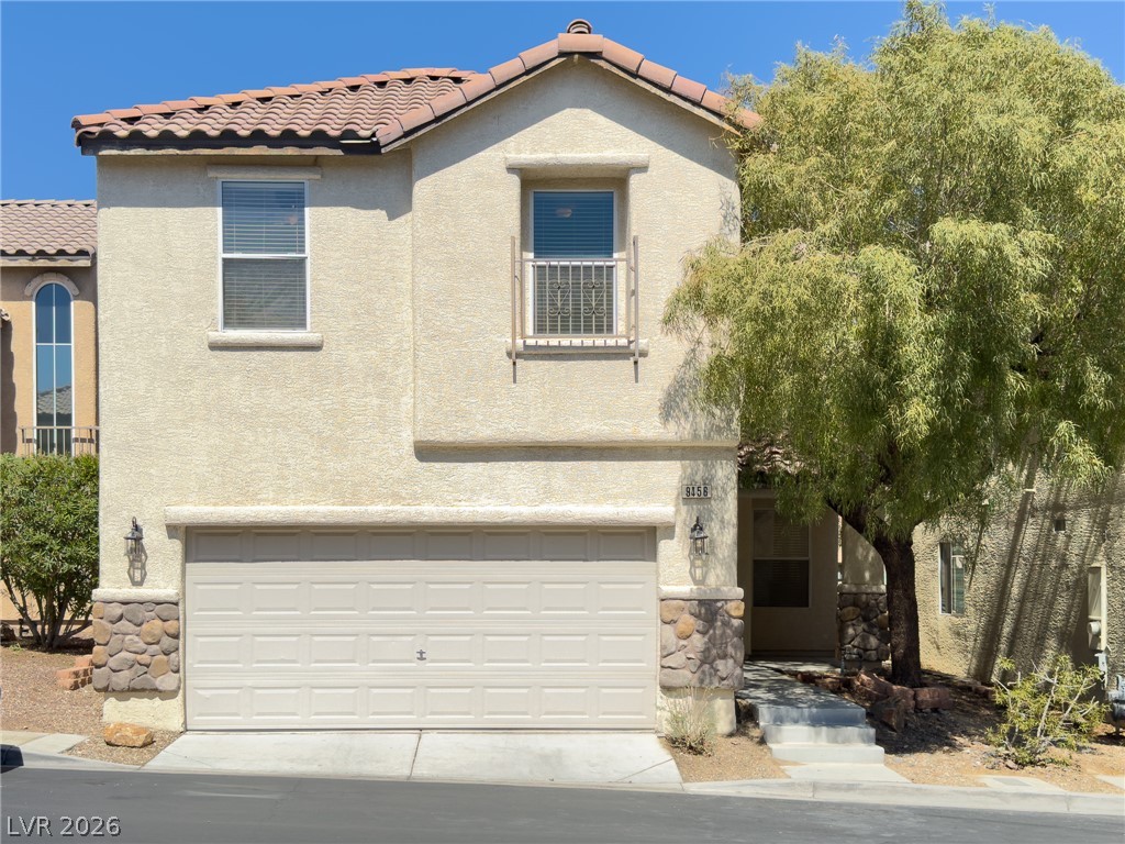 9456 Grandview Spring Avenue Las Vegas, NV 89166 - Photo 1 of 49 A well-maintained stucco home with a garage and mature tree offers inviting curb appeal.