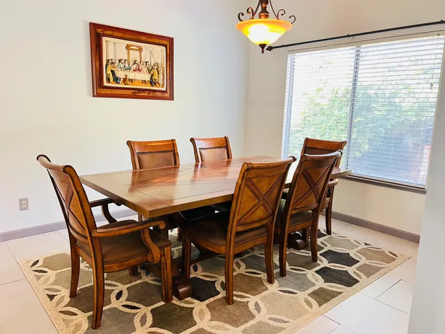 a view of a dining room with furniture and a window