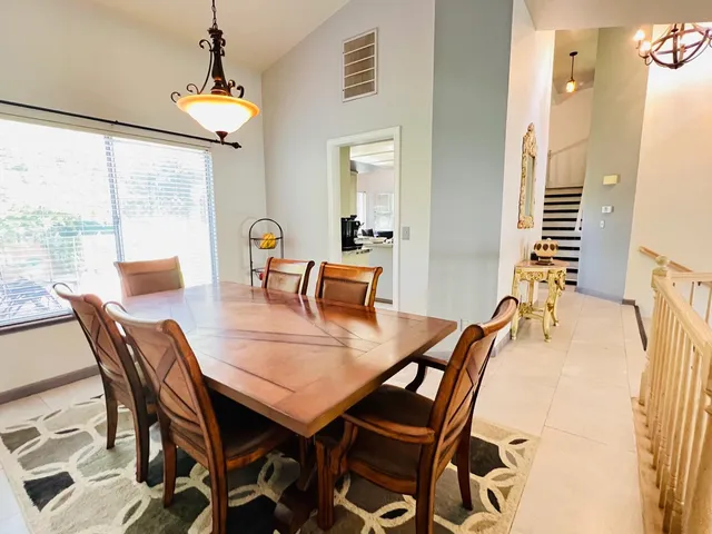 a dining room with furniture and window