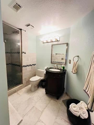 a bathroom with a toilet sink and shower