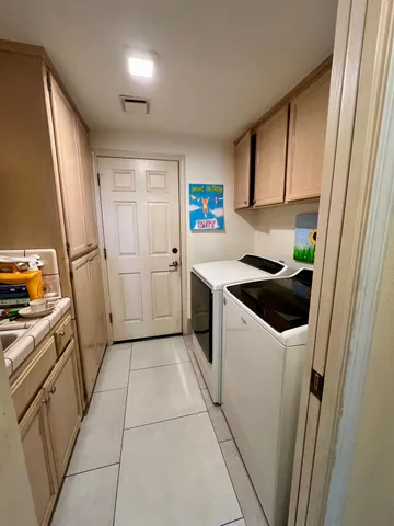 a kitchen with a sink a stove top oven and a refrigerator