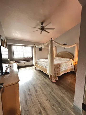 a bedroom with a bed next to a window