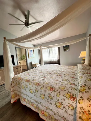 a bedroom with a large bed and a window