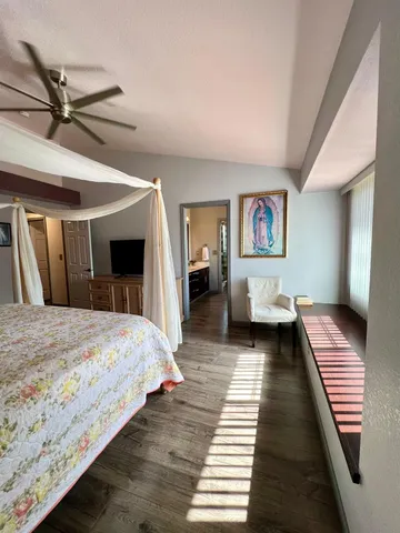 a bedroom with a large bed and a walk in closet