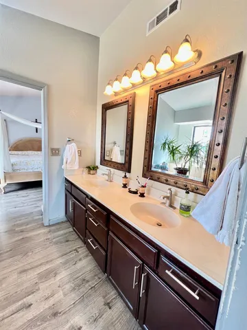 a bathroom with a double vanity sink and a mirror
