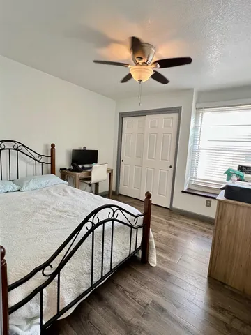 a view of a livingroom with furniture wooden floor and a ceiling fan