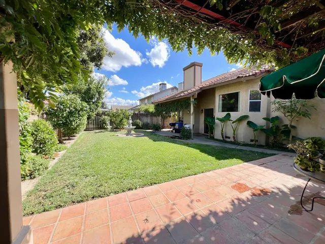 a view of a backyard with sitting area and furniture