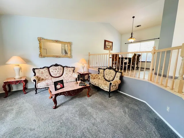 a view of a room with lots of white furniture