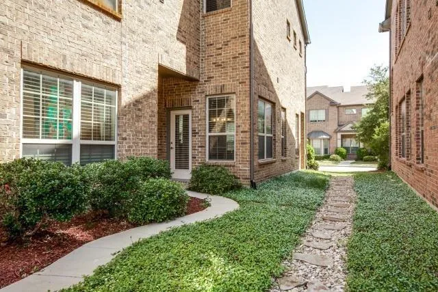 a view of a brick building next to a yard