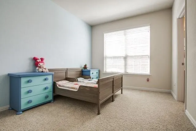 a bed room with a bed and a window