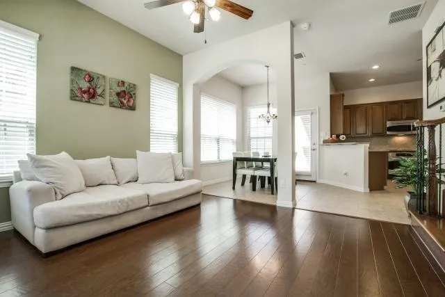 a living room with furniture and a chandelier