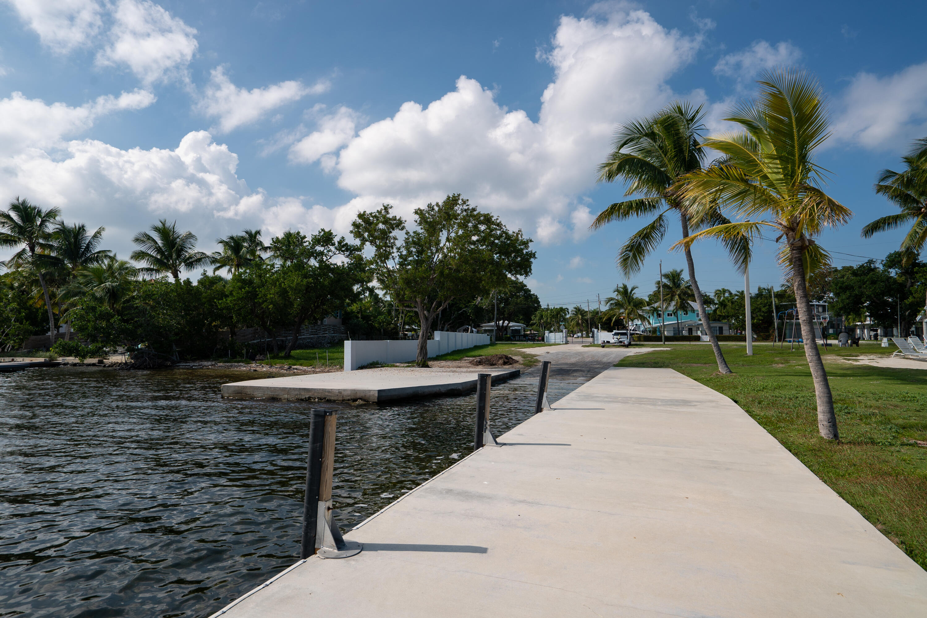 16 Jewfish Avenue Key Largo, FL 33037 - Photo 57 of 69 a view of swimming pool that has lawn chairs with plants and trees