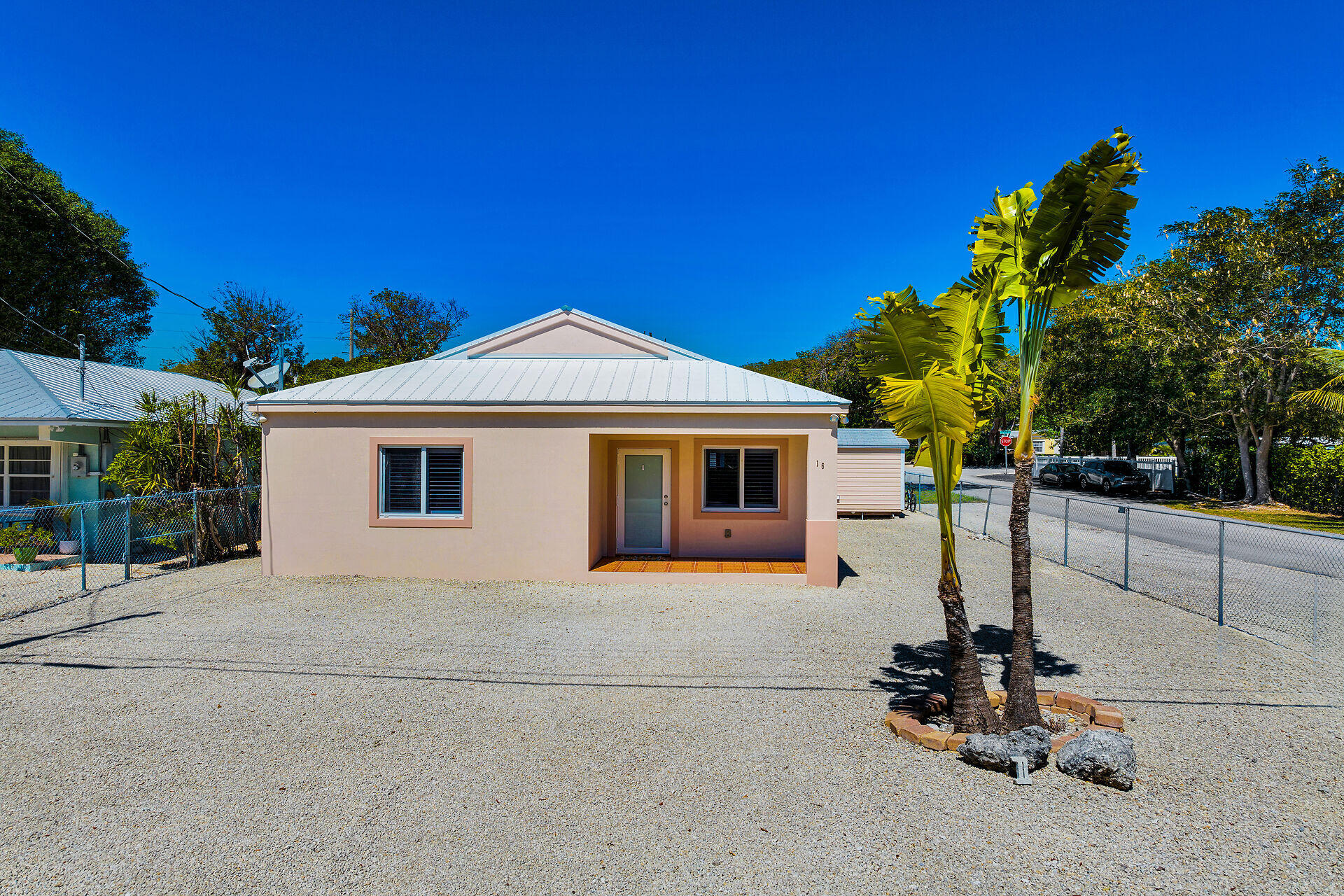 16 Jewfish Avenue Key Largo, FL 33037 - Photo 6 of 69 a front view of a house with a garage