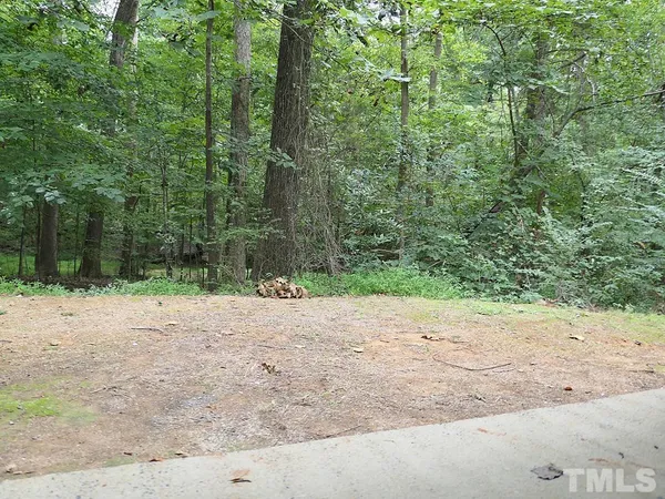 a wooden bench with view of road