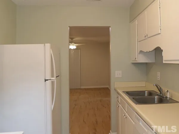 a kitchen with stainless steel appliances a refrigerator and a sink