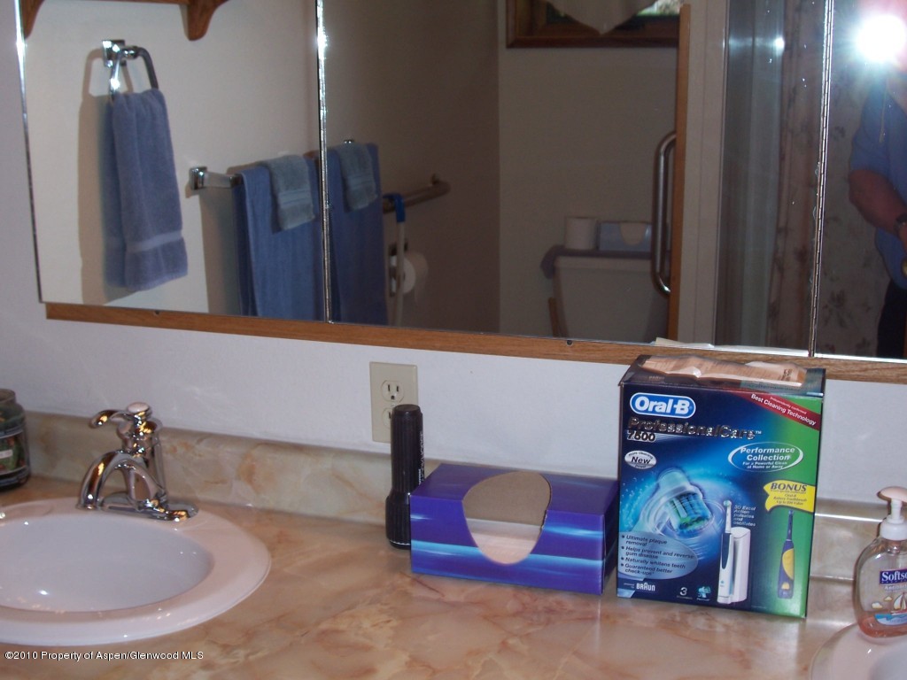 715 Buckeye Court Rifle, CO 81650 - Photo 6 of 16 a bathroom with a sink and mirror