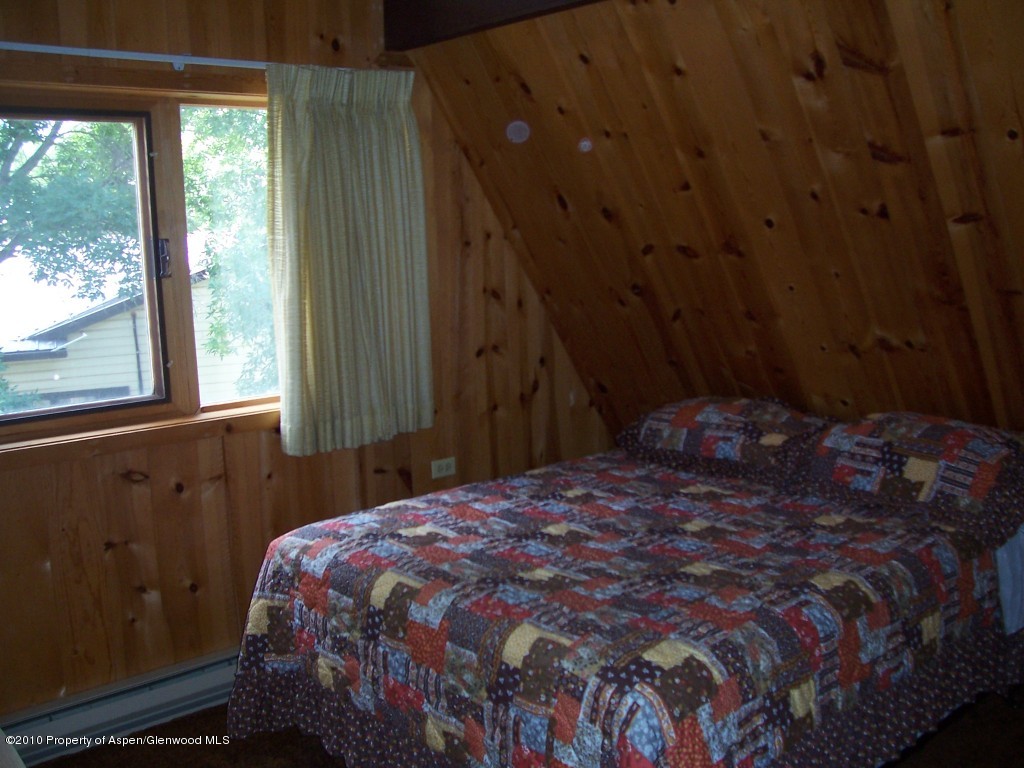715 Buckeye Court Rifle, CO 81650 - Photo 7 of 16 a bed sitting in a bedroom next to a window