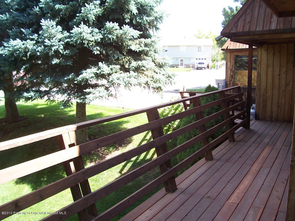 715 Buckeye Court Rifle, CO 81650 - Photo 10 of 16 a view of a balcony with wooden floor and outdoor space