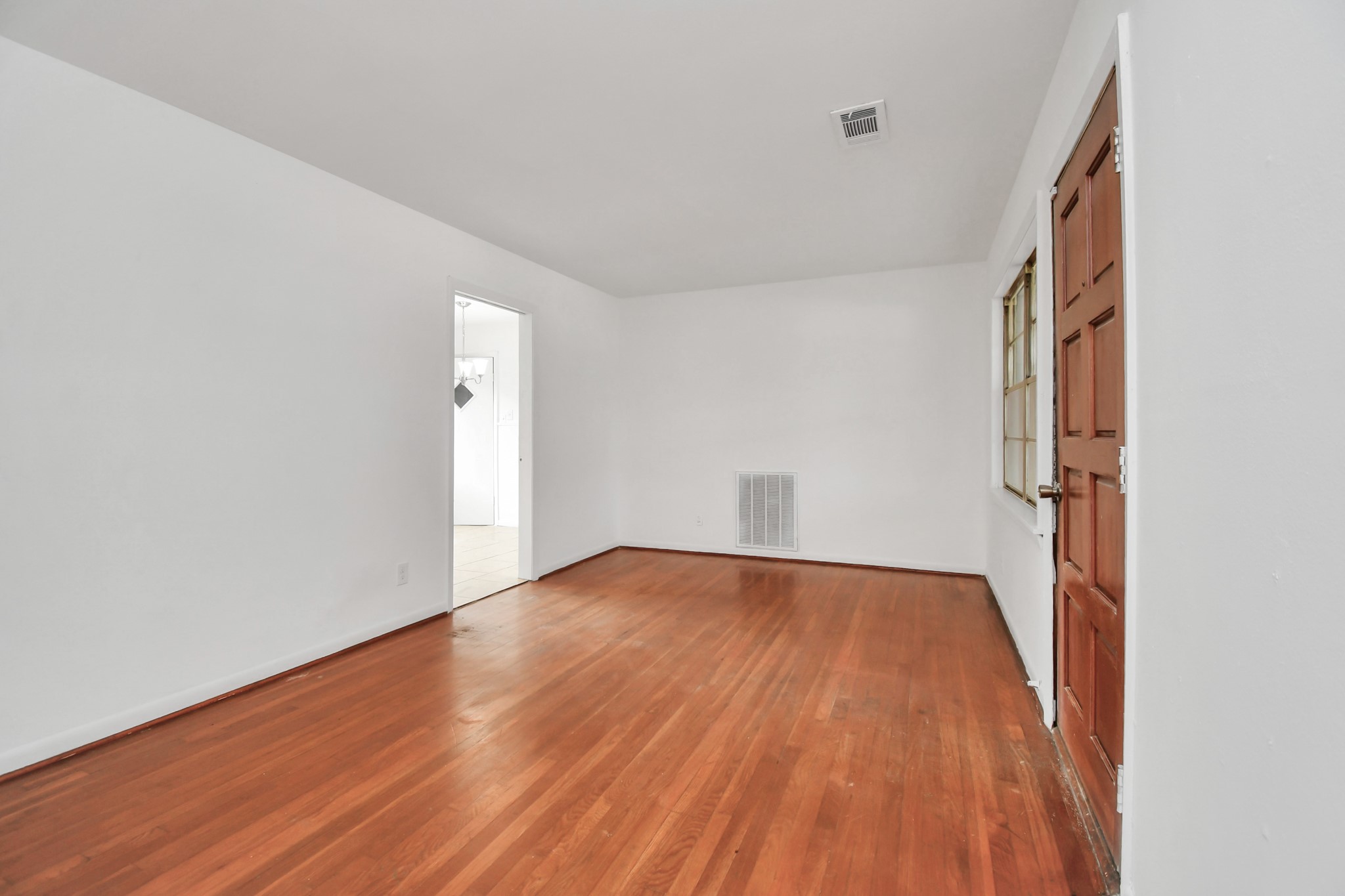 8534 Fillmore Street Houston, TX 77029 - Photo 7 of 39 Living room featuring original wood flooring and abundant natural light.